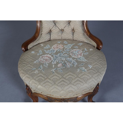 339 - A VICTORIAN WALNUT NURSING CHAIR having an encircling frame with foliate surmount, button back quilt... 