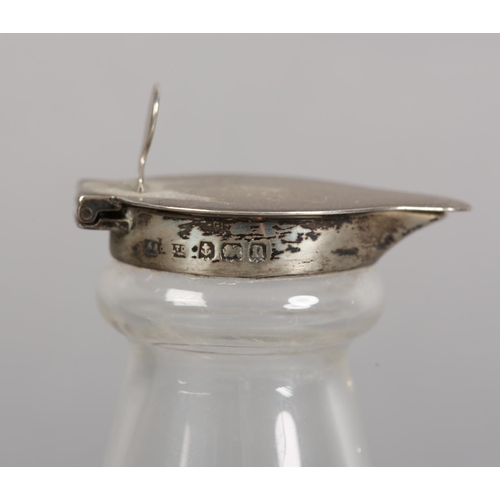 216 - A GEORGE V SILVER TOPPED GLASS WHISKEY NOGGIN, Birmingham 1912, conical with star cut circular base,... 