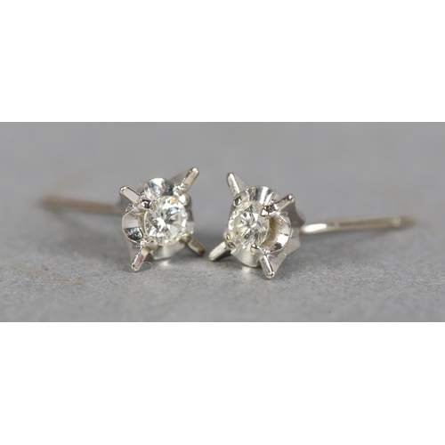 237 - A PAIR OF DIAMOND STUD EARRINGS, each set to the centre with a brilliant cut stone within a star of ... 