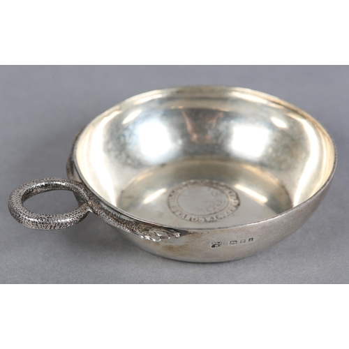 214 - A GEORGE V SILVER WINE TASTER, London 1924 D&J Welby, circular with serpentine handle and coin base,... 