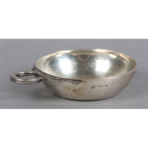 214 - A GEORGE V SILVER WINE TASTER, London 1924 D&J Welby, circular with serpentine handle and coin base,... 