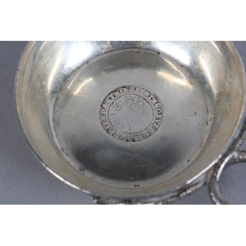 214 - A GEORGE V SILVER WINE TASTER, London 1924 D&J Welby, circular with serpentine handle and coin base,... 