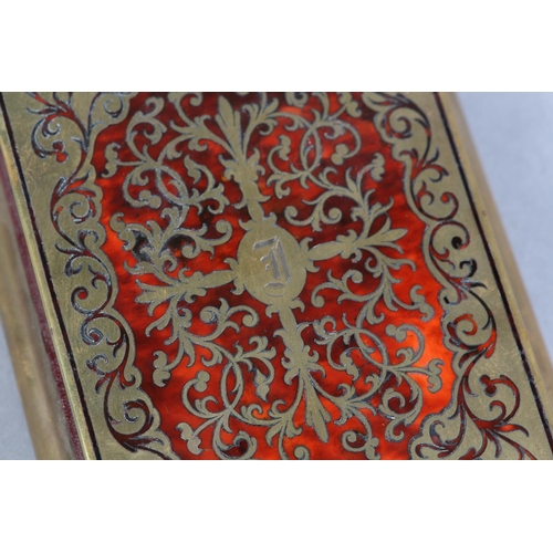 143 - A 19TH CENTURY BOULLE DESK PAD, having cut brass strapwork on a red tortoiseshell ground, etched wit... 