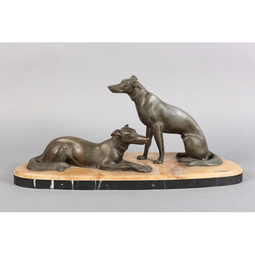 146 - AFTER DELORE AN ART DECO SPELTER FIGURE GROUP,  of a pair of lurchers seated and recumbent on a pink... 