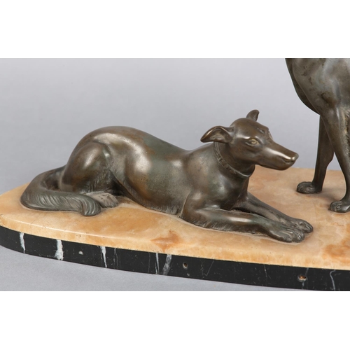 146 - AFTER DELORE AN ART DECO SPELTER FIGURE GROUP,  of a pair of lurchers seated and recumbent on a pink... 