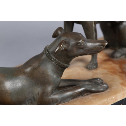 146 - AFTER DELORE AN ART DECO SPELTER FIGURE GROUP,  of a pair of lurchers seated and recumbent on a pink... 