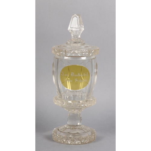 179 - A BOHEMIAN GLASS GOBLET AND COVER, the cover having hobnail decoration, the body with panel of amber... 