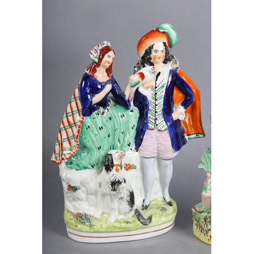 152 - A MID 19TH CENTURY STAFFORDSHIRE POTTERY FIGURE GROUP of a young man and girl sitting beneath a bowe... 