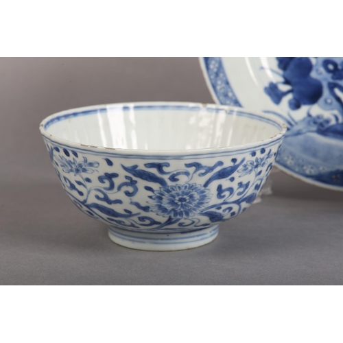 174 - AN 18TH CENTURY CHINESE BLUE AND WHITE PLATE painted with rocks issuing blossom within a diaper bord... 