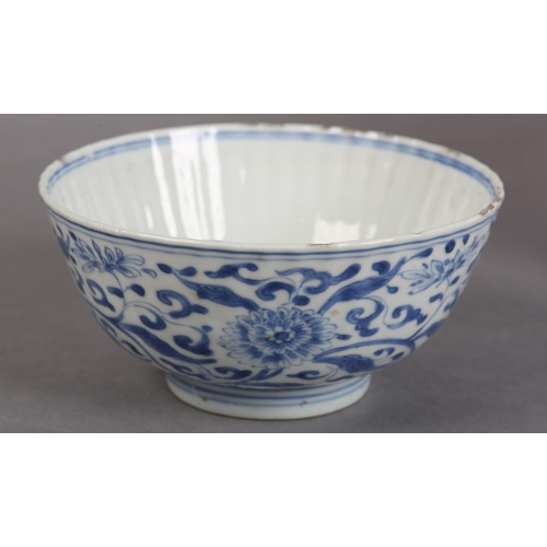 174 - AN 18TH CENTURY CHINESE BLUE AND WHITE PLATE painted with rocks issuing blossom within a diaper bord... 