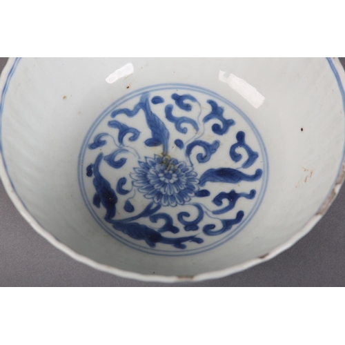 174 - AN 18TH CENTURY CHINESE BLUE AND WHITE PLATE painted with rocks issuing blossom within a diaper bord... 