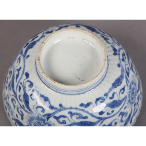 174 - AN 18TH CENTURY CHINESE BLUE AND WHITE PLATE painted with rocks issuing blossom within a diaper bord... 