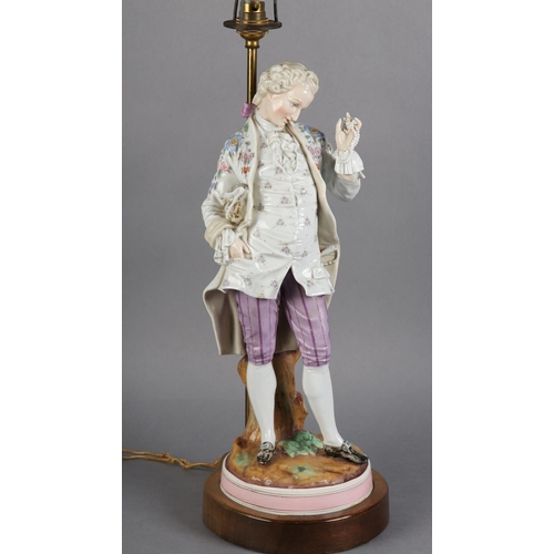 168 - A LATE 19TH CENTURY GERMAN PORCELAIN FIGURE OF A GENTLEMAN IN ELEGANT DRESS, proffering a string of ... 