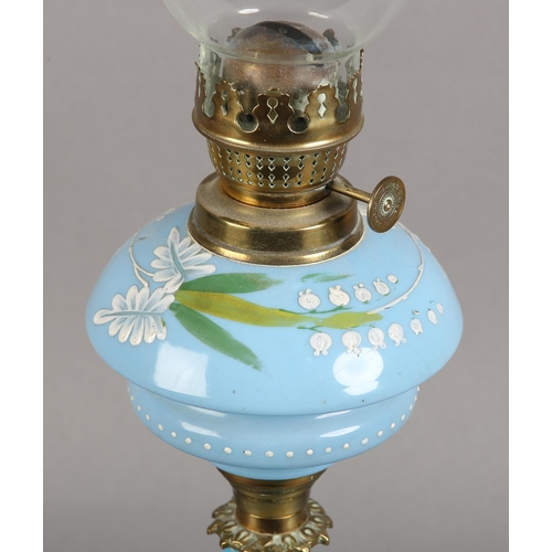 100 - A VICTORIAN MID BLUE GLASS TABLE LAMP, enamelled in white and green with lily of the valley and othe... 