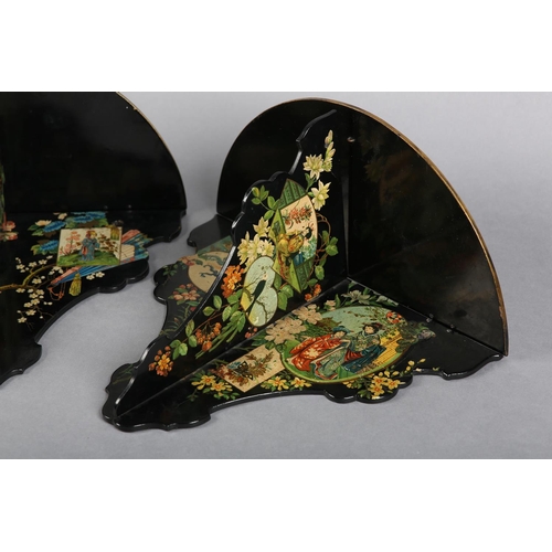 318 - A PAIR OF AESTHETIC MOVEMENT BLACK PAPIER MACHE FOLDING WALL BRACKET, decorated with polychrome and ... 