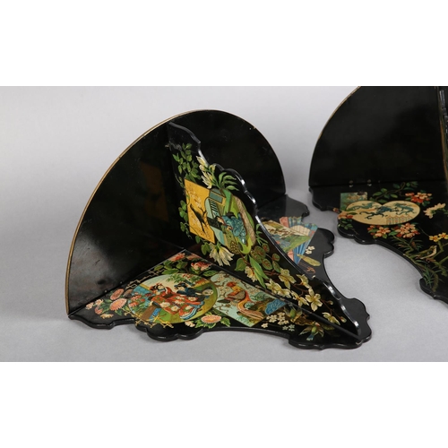 318 - A PAIR OF AESTHETIC MOVEMENT BLACK PAPIER MACHE FOLDING WALL BRACKET, decorated with polychrome and ... 