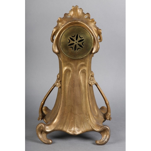 131 - AN ART NOUVEAU GILT METAL MANTEL CLOCK, having a circular porcelain dial with black Arabic numerals ... 