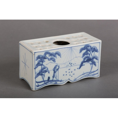 169 - AN ISIS POTTERY (OXFORD) TIN GLAZE DELFTWARE FLOWERBRICK painted in blue and white with a traveller ... 