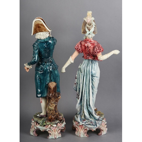 167 - A PAIR OF CONTINENTAL PORCELAIN FIGURES of a lady wearing bonnet and gathered dress, with arms exten... 