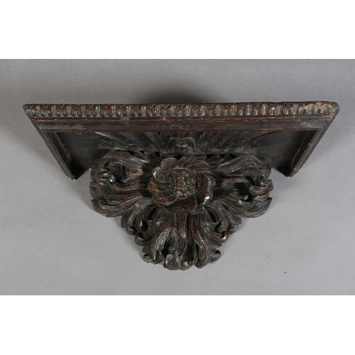 380 - A VICTORIAN OAK WALL BRACKET, rectangular with arcaded rim above a flower and foliate support, 72cm ... 