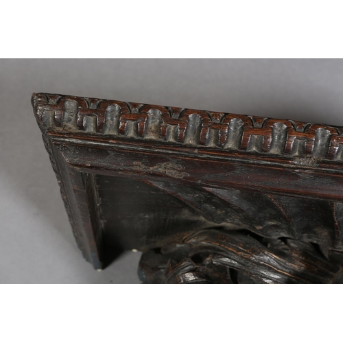 380 - A VICTORIAN OAK WALL BRACKET, rectangular with arcaded rim above a flower and foliate support, 72cm ... 