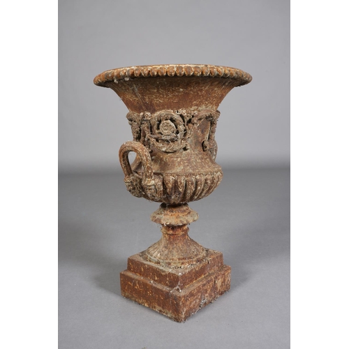 82 - A VICTORIAN CAST IRON GARDEN URN of two-handled campagna shape with band of scrolling flower and fol... 