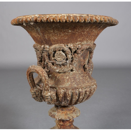 82 - A VICTORIAN CAST IRON GARDEN URN of two-handled campagna shape with band of scrolling flower and fol... 