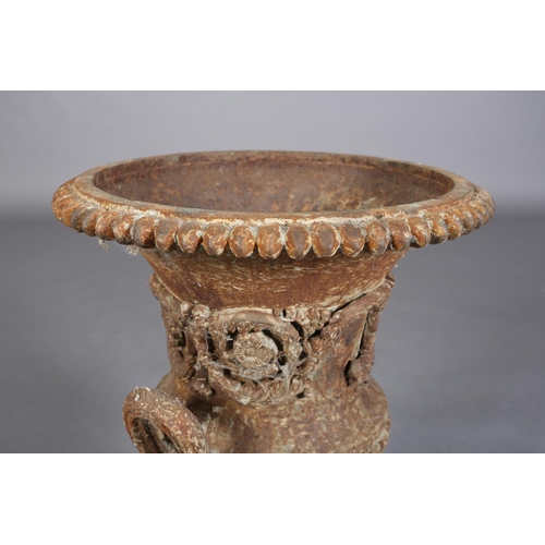 82 - A VICTORIAN CAST IRON GARDEN URN of two-handled campagna shape with band of scrolling flower and fol... 