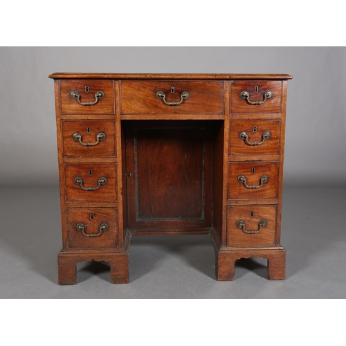 351 - A GEORGE III STYLE MAHOGANY KNEEHOLE DESK having a drawer to the centre above a recessed cupboard, f... 