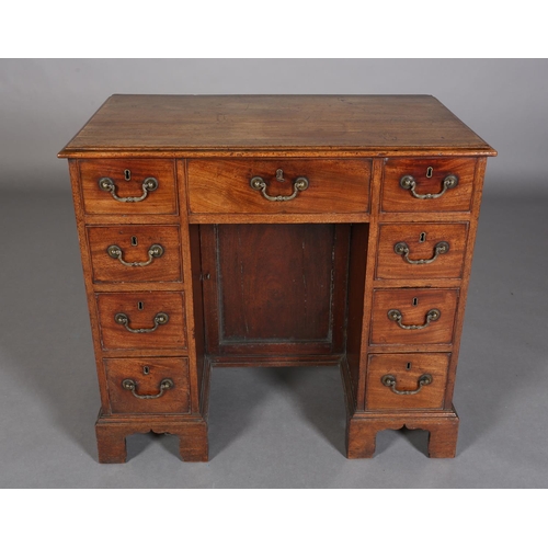 351 - A GEORGE III STYLE MAHOGANY KNEEHOLE DESK having a drawer to the centre above a recessed cupboard, f... 