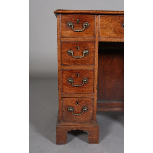 351 - A GEORGE III STYLE MAHOGANY KNEEHOLE DESK having a drawer to the centre above a recessed cupboard, f... 