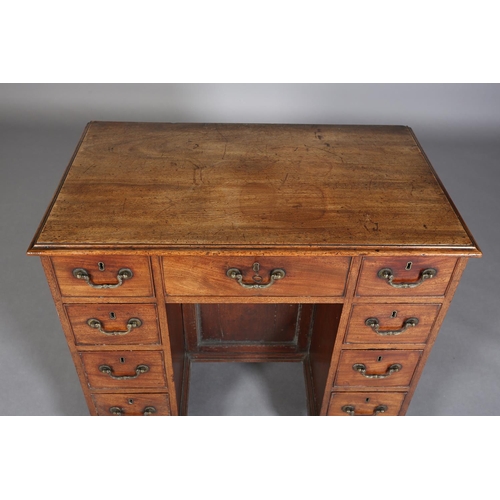 351 - A GEORGE III STYLE MAHOGANY KNEEHOLE DESK having a drawer to the centre above a recessed cupboard, f... 