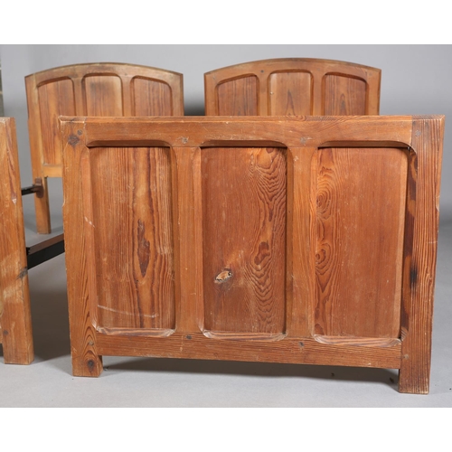 315 - A PAIR OF ARTS & CRAFTS PITCH PINE SINGLE BEDSTEADS, having arched and rectangular triple indented p... 