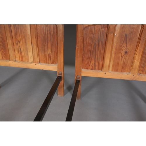 315 - A PAIR OF ARTS & CRAFTS PITCH PINE SINGLE BEDSTEADS, having arched and rectangular triple indented p... 