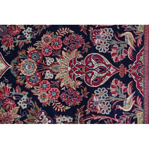 309 - A TABRIZ CARPET, the dark blue field having a pictorial landscape with Mosque to the central medalli... 