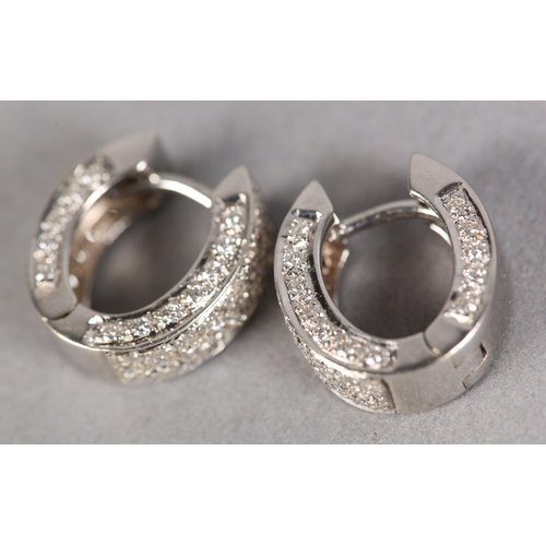 235 - A PAIR OF DIAMOND EARRINGS, each set with brilliant cut stones to a hinged cuff fitting in white met... 