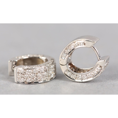 235 - A PAIR OF DIAMOND EARRINGS, each set with brilliant cut stones to a hinged cuff fitting in white met... 