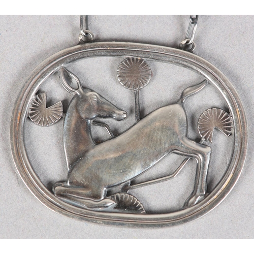 262 - A GEORG JENSEN SILVER KNEELING HIND PENDANT designed by Arno Malinowski hung on a silver fetter link... 