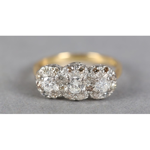 241 - A DIAMOND CLUSTER RING c1970 claw set with three graduated brilliant cut stones, raised against a su... 