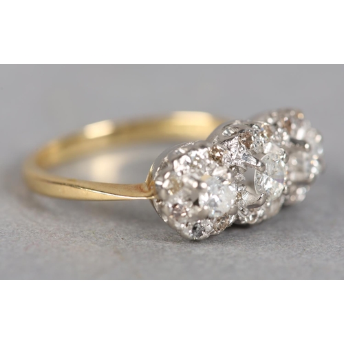 241 - A DIAMOND CLUSTER RING c1970 claw set with three graduated brilliant cut stones, raised against a su... 