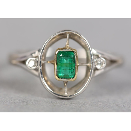 243 - AN ART DECO STYLE EMERALD AND DIAMOND THREE STONE RING in 18ct white and yellow gold by Ogden’s of H... 