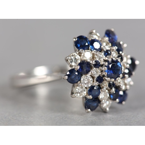 246 - A SAPPHIRE AND DIAMOND CLUSTER RING c.1970, the circular faceted sapphires and brilliant cut diamond... 