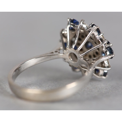 246 - A SAPPHIRE AND DIAMOND CLUSTER RING c.1970, the circular faceted sapphires and brilliant cut diamond... 