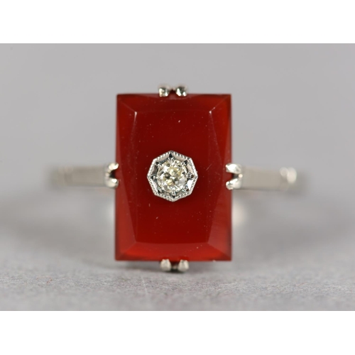 249 - AN ART DECO CORNELIAN AND DIAMOND RING in 14ct white gold, the brilliant cut diamond set within an o... 