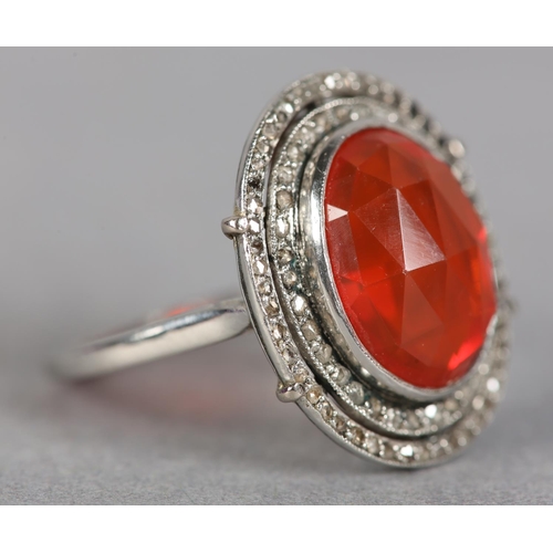 250 - AN ART DECO FIRE OPAL AND DIAMOND CLUSTER RING in platinum, collet set to the centre with an oval fa... 