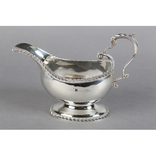 222 - A QUEEN ELIZABETH II SILVER SAUCE BOAT, Birmingham 1957, Charles Green & Co Ltd, with leaf capped sc... 