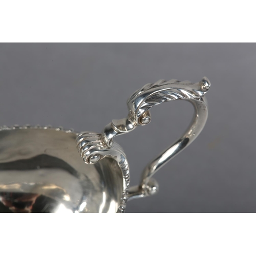 222 - A QUEEN ELIZABETH II SILVER SAUCE BOAT, Birmingham 1957, Charles Green & Co Ltd, with leaf capped sc... 