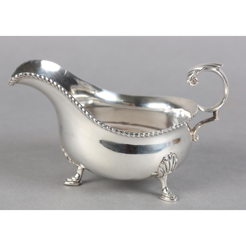 223 - A GEORGE V SILVER SAUCE BOAT, Sheffield 1927, Harrison Brother and Howson, leaf capped 'C' scroll ha... 