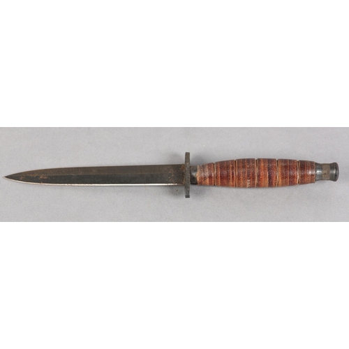 106 - A COMMANDO STYLE DAGGER, with tapering fluttered diamond shaped blued blade, iron cross piece, stack... 