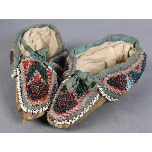 69 - A PAIR OF MID 19TH CENTURY CHILD'S BEADED SLIPPERS, worked in turquoise, teal, aubergine, green and ... 